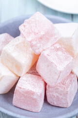 Turkish delight or lokum confection rose and lemon flavored, vertical, closeup