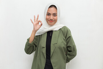 young asian beautiful muslim woman with ok sign tumb up isolated on white background
