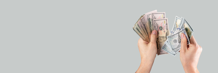 Banner with hands counting US dollar bills on grey background. Income and expenses calculation concept. Copyspace. High quality photo