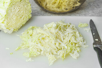 Cut bulb of Chinese cabbage on a cutting board. Low-calorie food