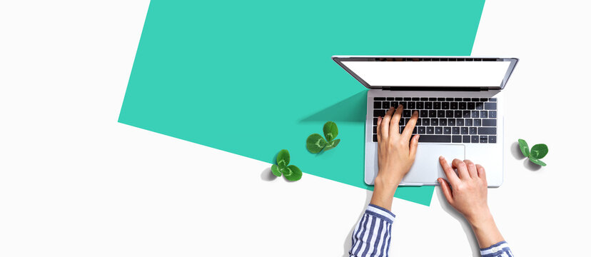 Laptop computer with shamrock leaves - flat lay