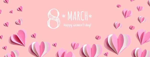 Happy women's day message with pink paper hearts - flat lay