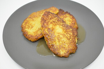 Pumpkin pancakes with apricot jam on a gray plate. Light background.