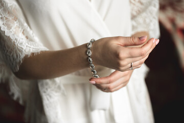 Obraz na płótnie Canvas The wedding day. A luxurious bracelet on the bride's hand is a close-up of the bride's hand before the wedding. Wedding accessories.