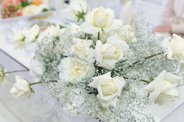 Wedding floral decor in white at a banquet in a restaurant.