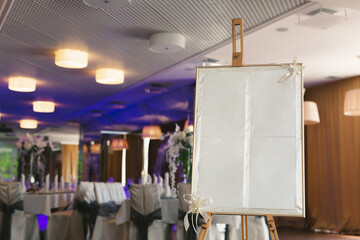 A plaque that stands in a restaurant with a wedding inscription. Layout for the invitation