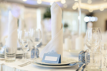 Beautiful setting of the wedding banquet table in the restaurant with the name of the guest.