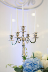 Wedding candle holder with floral decoration at the wedding banquet.