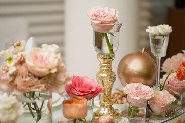 Table setting at a luxury wedding and Beautiful flowers on the table. wedding decor, flowers, pink and gold decor, candles.