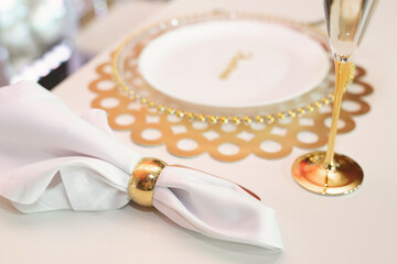 Luxurious setting of a festive table in a golden style.