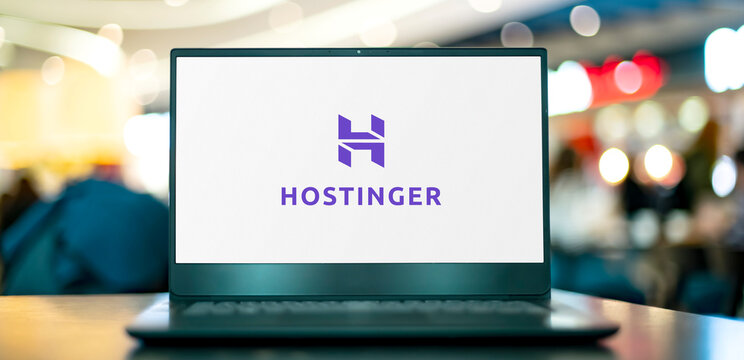 Laptop computer displaying logo of Hostinger