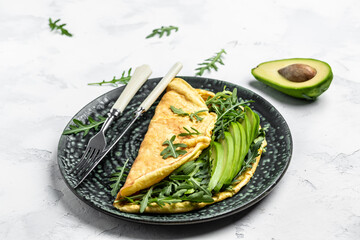 Omelet and Salad with green vegetables avocado and arugula, Delicious vegan, vegetarian breakfast