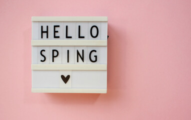 lightbox with text Hello spring on pink background. Top view Flat lay Springtime concept