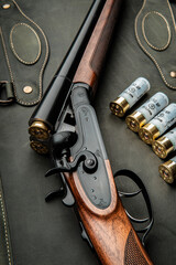 Classic trigger double-barreled hunting rifle on a green back. Smooth-bore hunting rifle open for...