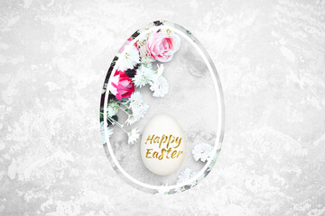Fototapeta na wymiar Shining Easter egg and flowers in egg shaped hole on a concrete background. Lettering Happy Easter. Red and pink roses, white daisies.Top view, close up, copy space