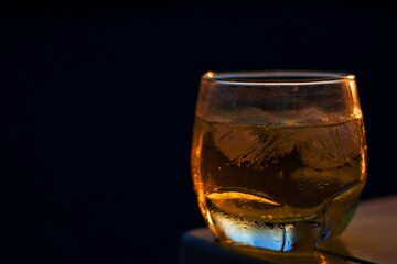 Whiskey glass on a dark background table