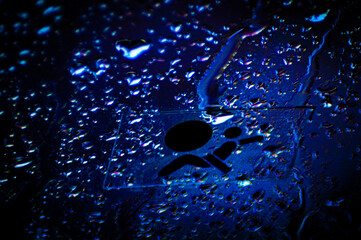 Drops on the glass over the darkness of the night