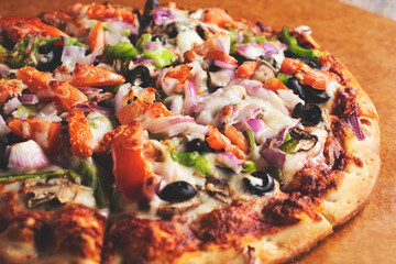 A view of a meat and veggie pizza pie.