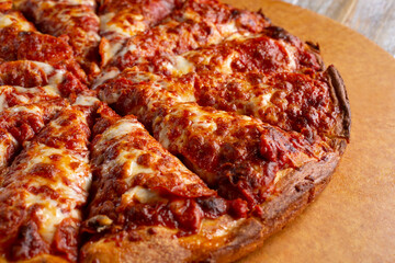 A view of a deep dish style pepperoni pizza.