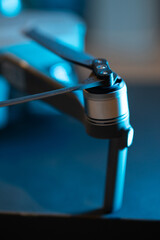 Obraz premium Close-up of the propellers and brushless motor of the Dji mavic 2 pro drone, diode fire. Repair and replacement of quadrocopter blades. Drone maintenance.