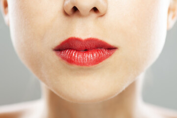 Close up abstract portrait of a beautiful caucasian girl with red lipstick.