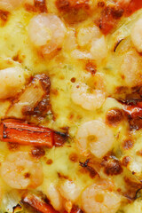 Macro photo of cheesy pizza topped with bell peppers and shrimps