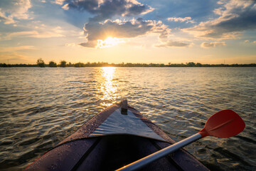 kayak with sunset in the background.
