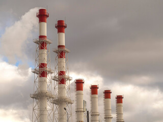 The chimneys from which the smoke comes out against the background of the sky. The concept of...