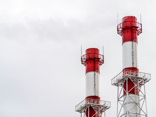 The chimneys from which the smoke comes out against the background of the sky. The concept of...