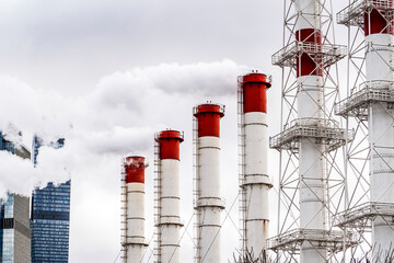 The chimneys from which the smoke comes out against the background of the sky. The concept of...