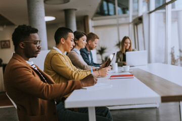 Group of business people working together and preparing new project on a meeting in office