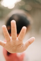 Obraz premium The little girl's hand gesture with open fingers shows refuse