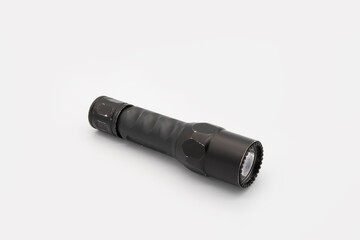 isolated tactical flashlight for a weapon mounting such as gun on white background