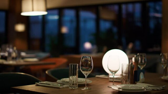 Modern hotel restaurant table in evening cafe. Woman waiting for romantic dinner