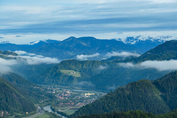 Panoramic view on the Eisenerzer Alps from below mount Roethelstein near Mixnitz in Styria, Austria. Snow capped mountain of the Ennstal Alps beyond the Grazer Bergland in Styria, Austria. Village