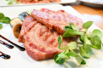 Roast meat served on a plate in a restaurant. Fried pork.