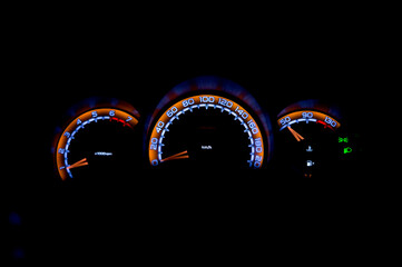 The dashboard of a modern car glow at night 