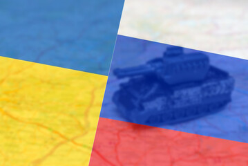 Miniature toy war tank on the map.Flags of Russia vs Ukraine,Ukraine vs Russia war, country flags.