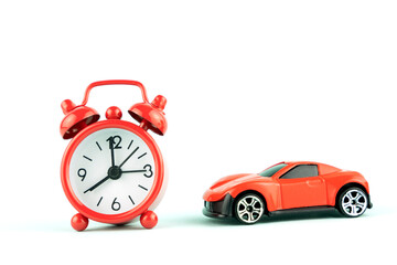 red alarm clock and toy car, the concept of buying a new car.