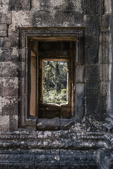 View from window of ancient temple with stone carvings in Angkor Wat, Siem Reap, Cambodia