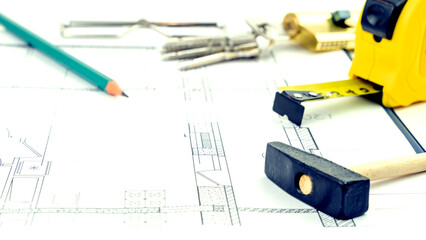 Naklejka premium House keys and roulette on the drawings. the concept of construction and purchase of new housing