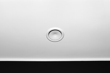 Domestic mechanical ventilation with heat recovery, a visible blowing anemostat on the ceiling in the room, black wall.