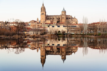 Fototapeta na wymiar Landscape of the city of Salamanca and its cathedral reflected in the calm waters of the Tormes River