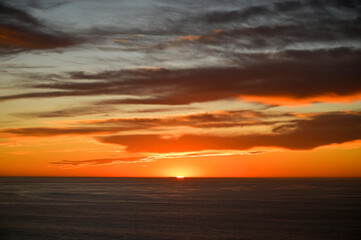 Fototapeta na wymiar Sun sinking into the Pacific Ocean in Big Sur