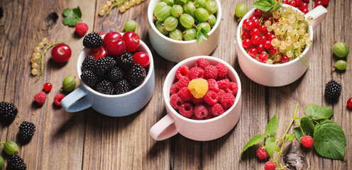 different berries on old wooden background