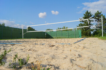 Beachvolleyballplatz mit weißem Netz und gelbem Sand, Tiefe Perspektive