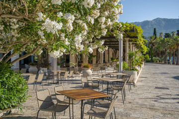 Cozy outdoor cafe in Budva old town at sunny day in Montenegro