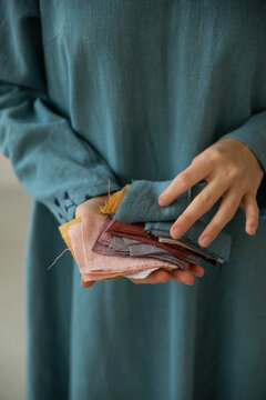 Female hands holding colourful pieces of linen tissue