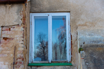 Fototapeta na wymiar Altes Fenster aus Holz in einer Verfallenen Mauer