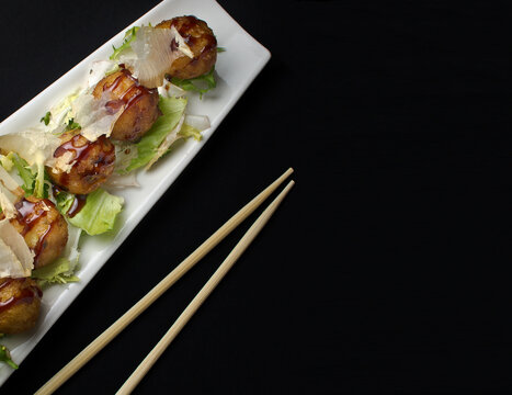 Japanese Food In A White Plate On Black Background. Top View. Banner